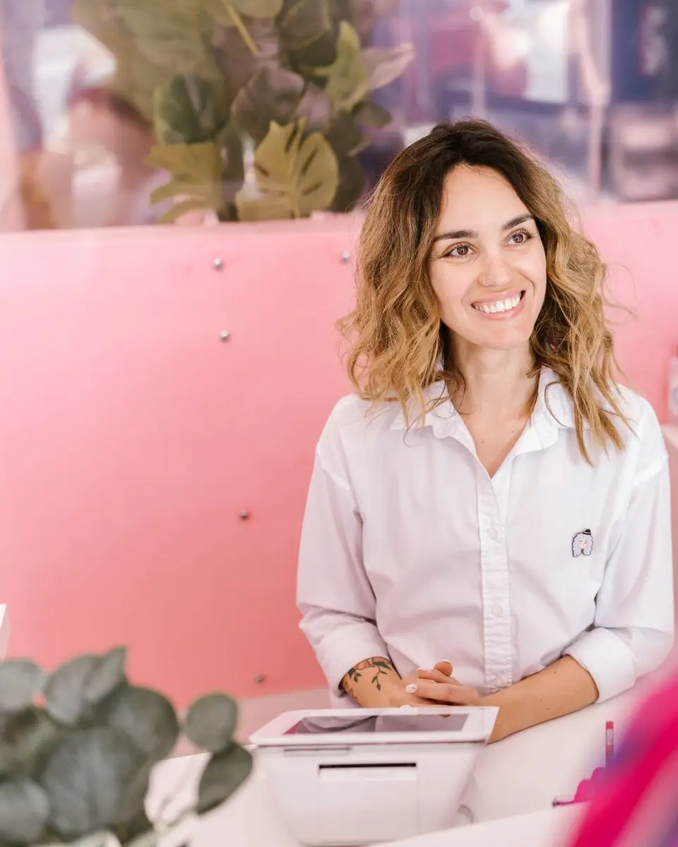 Smiling receptionist at a salon front desk