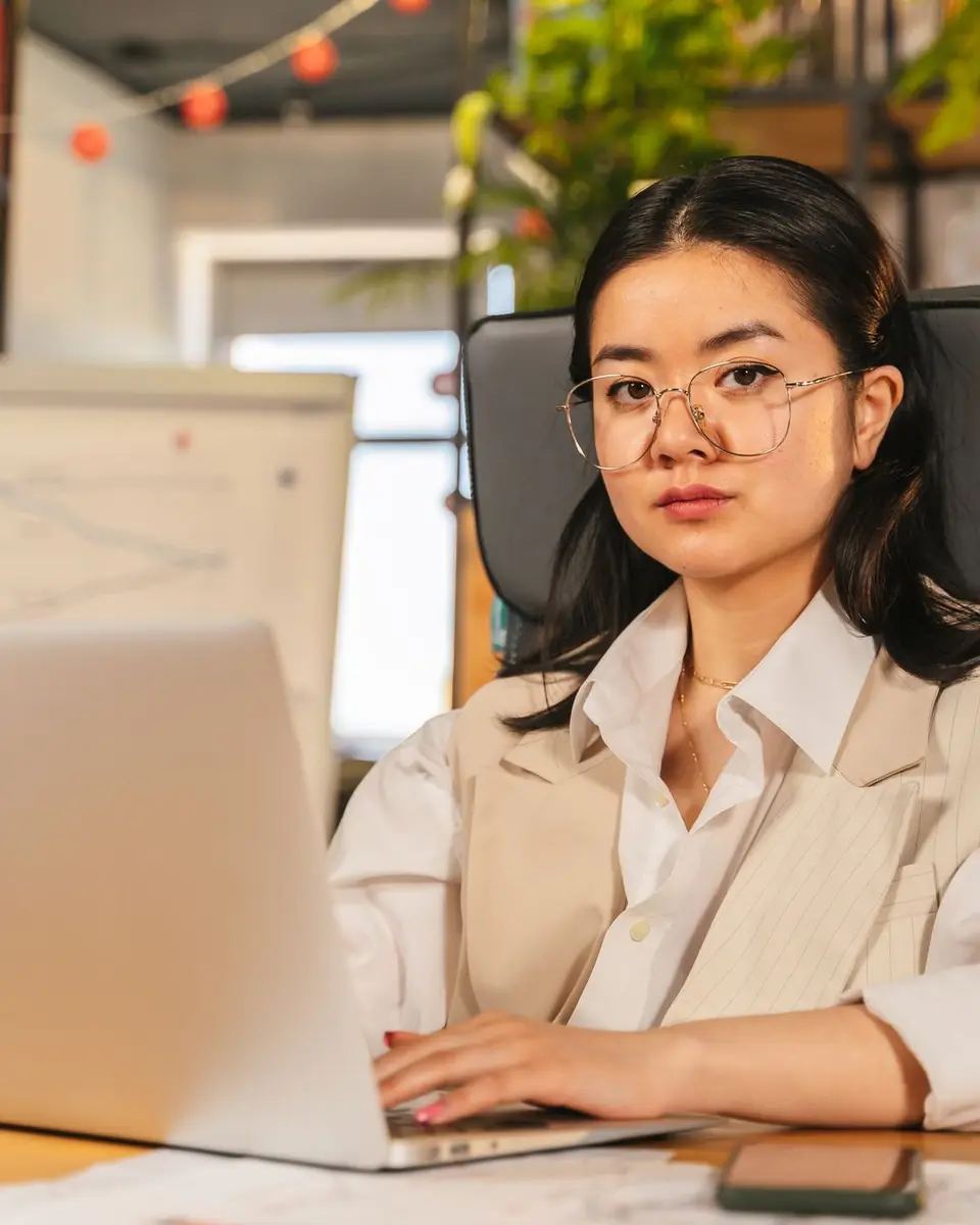 Product specialist working at a laptop in a bright studio office
