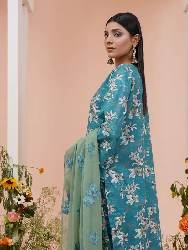 Model wearing a teal floral three-piece suit